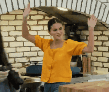 Selena Gomez in a kitchen raising the roof