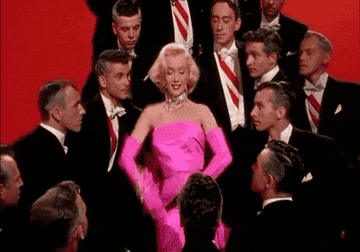 Marilyn Monroe surrounded by male suitors saying no flirtatiously