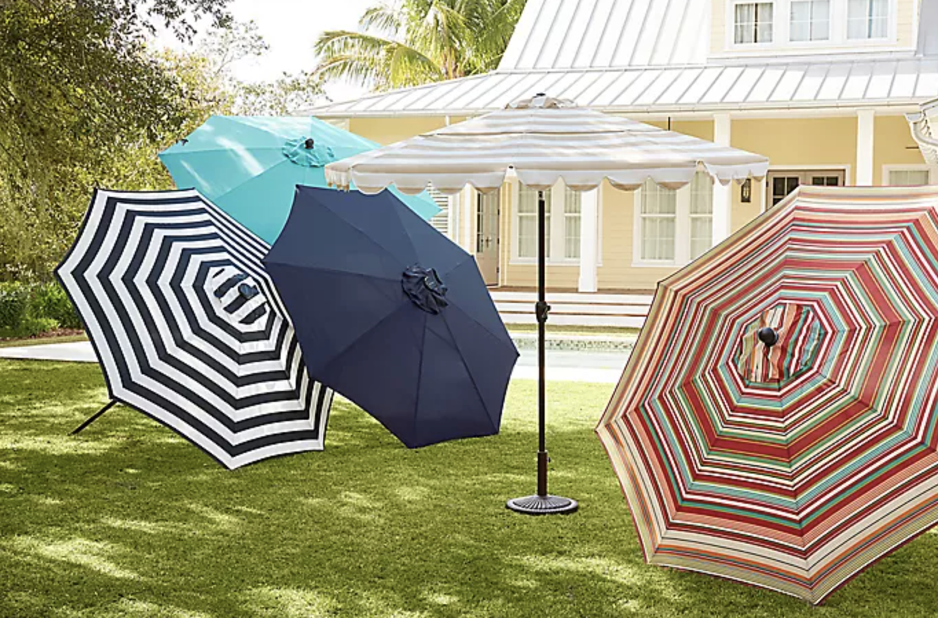 three of the umbrellas lying on a grass lawn