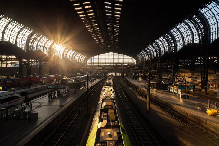 A train station with a sunbeam breaking through