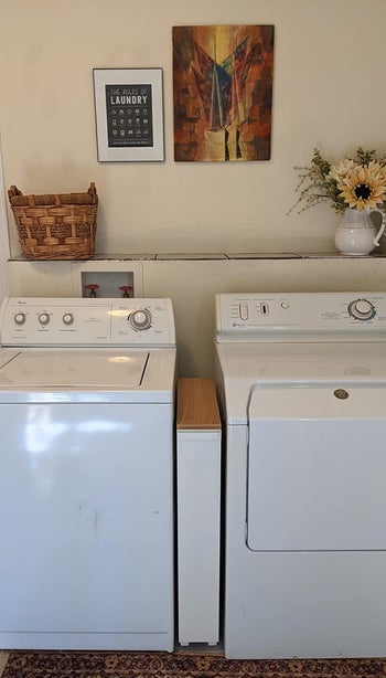 a reviewer shows the storage cart between a washer and dyer machine