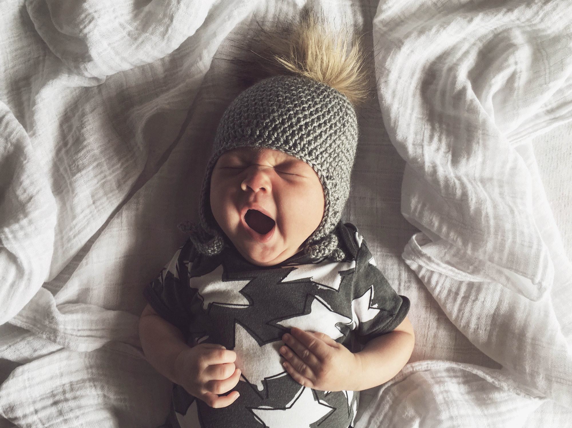 Infant waking up yawning after a big sleep