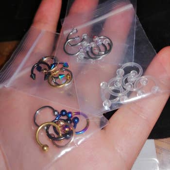 Reviewer holding four bags of bullnose rings
