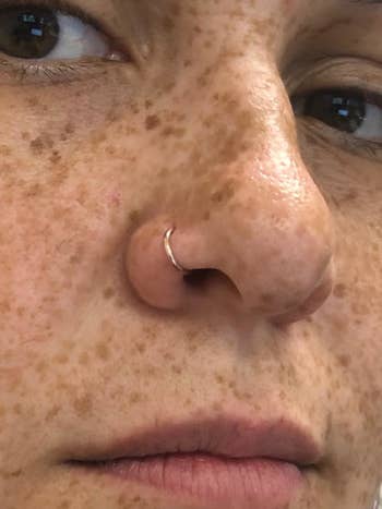 Reviewer wearing gold nose ring