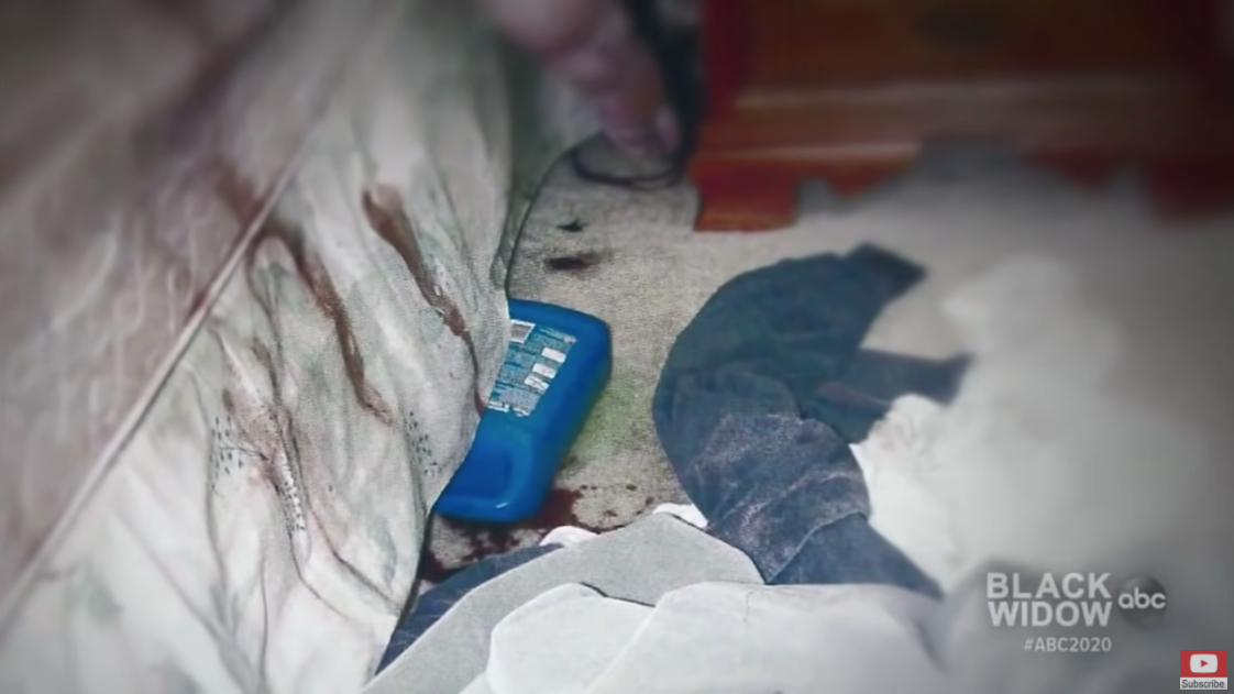 Crime scene photo of a bottle of antifreeze under the bed