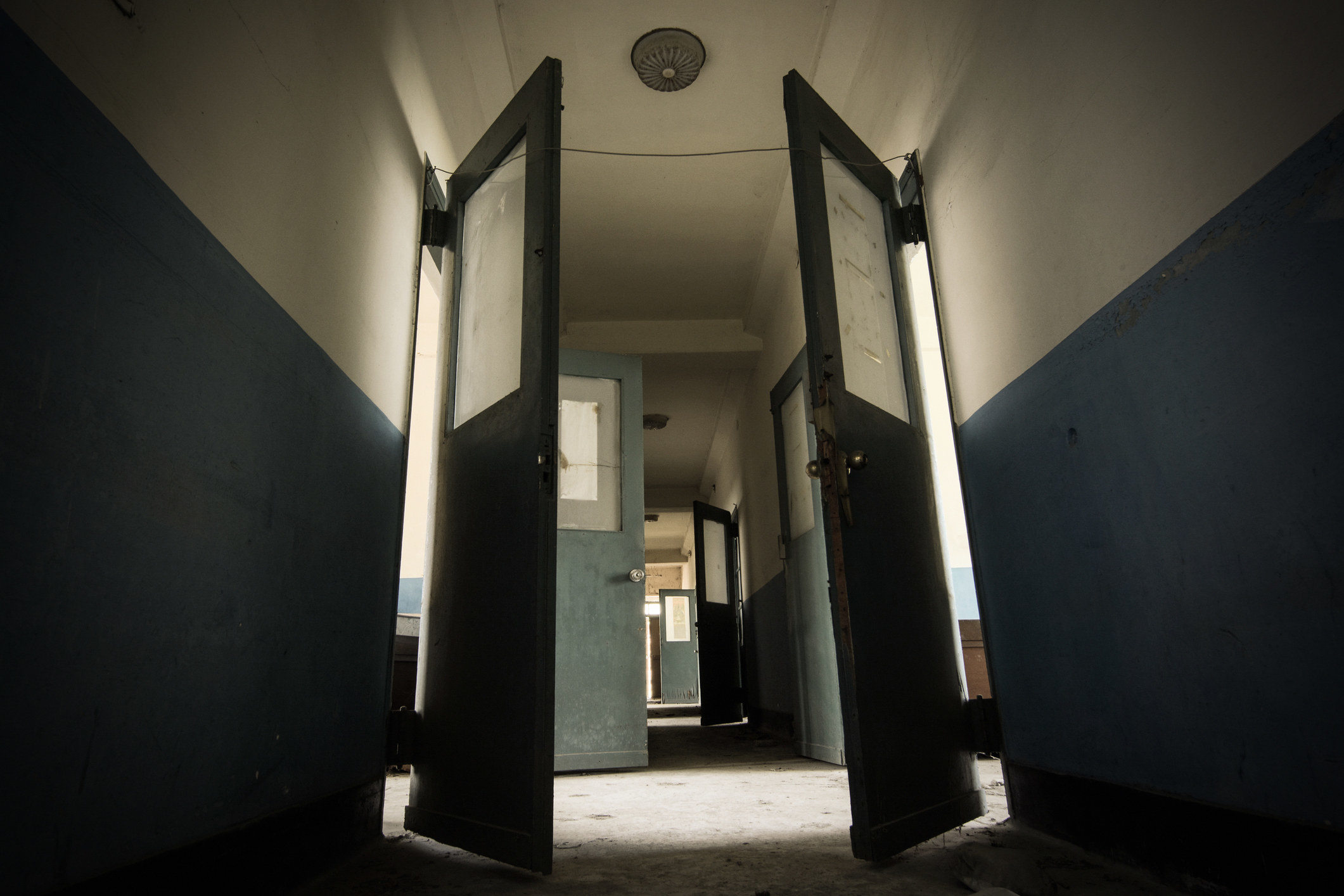 Dark hallway in a scary and possibly haunted abandoned sanatorium