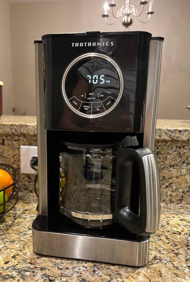 reviewer image of the coffee maker on a granite countertop