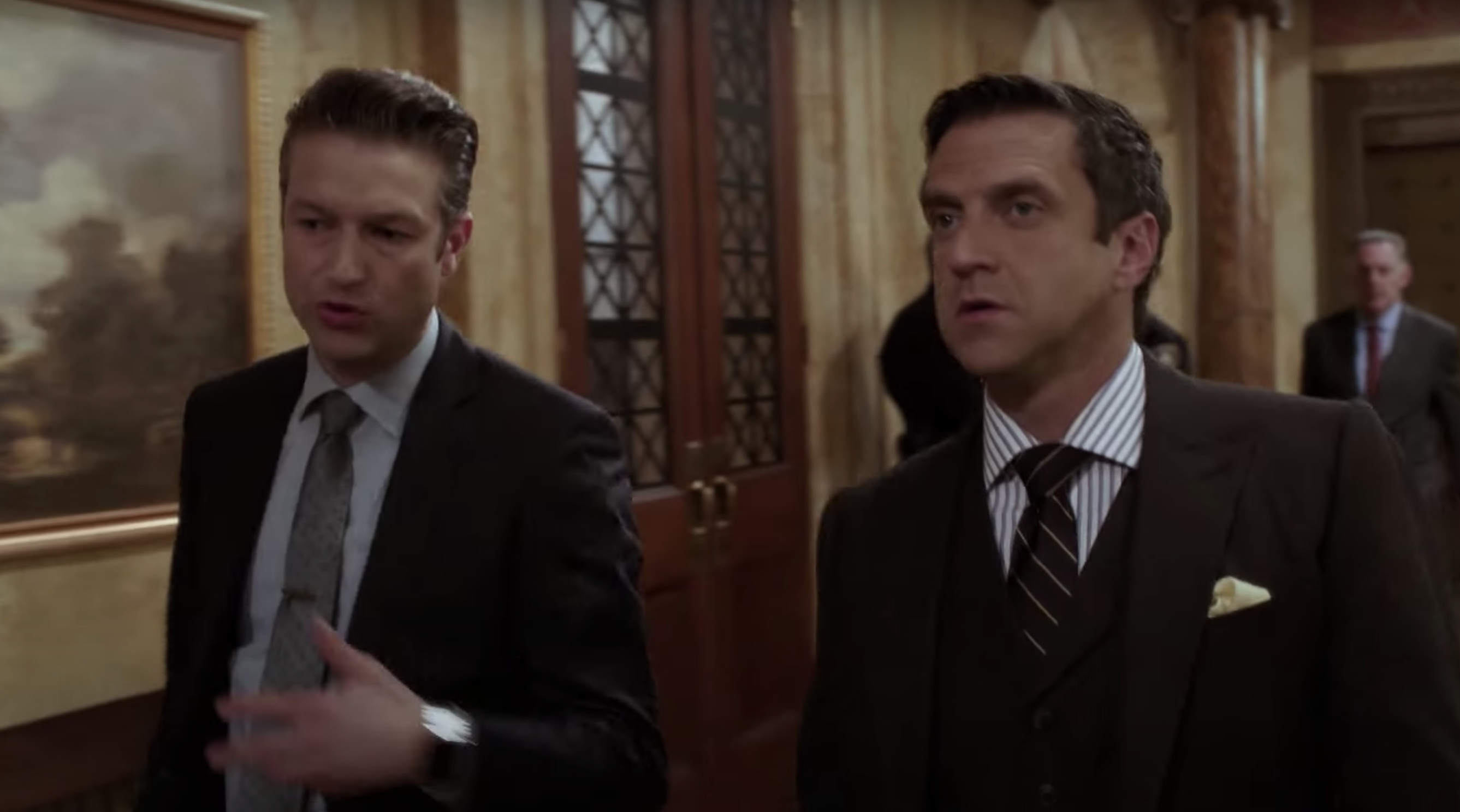 Sonny and Rafael walking in a courtroom building