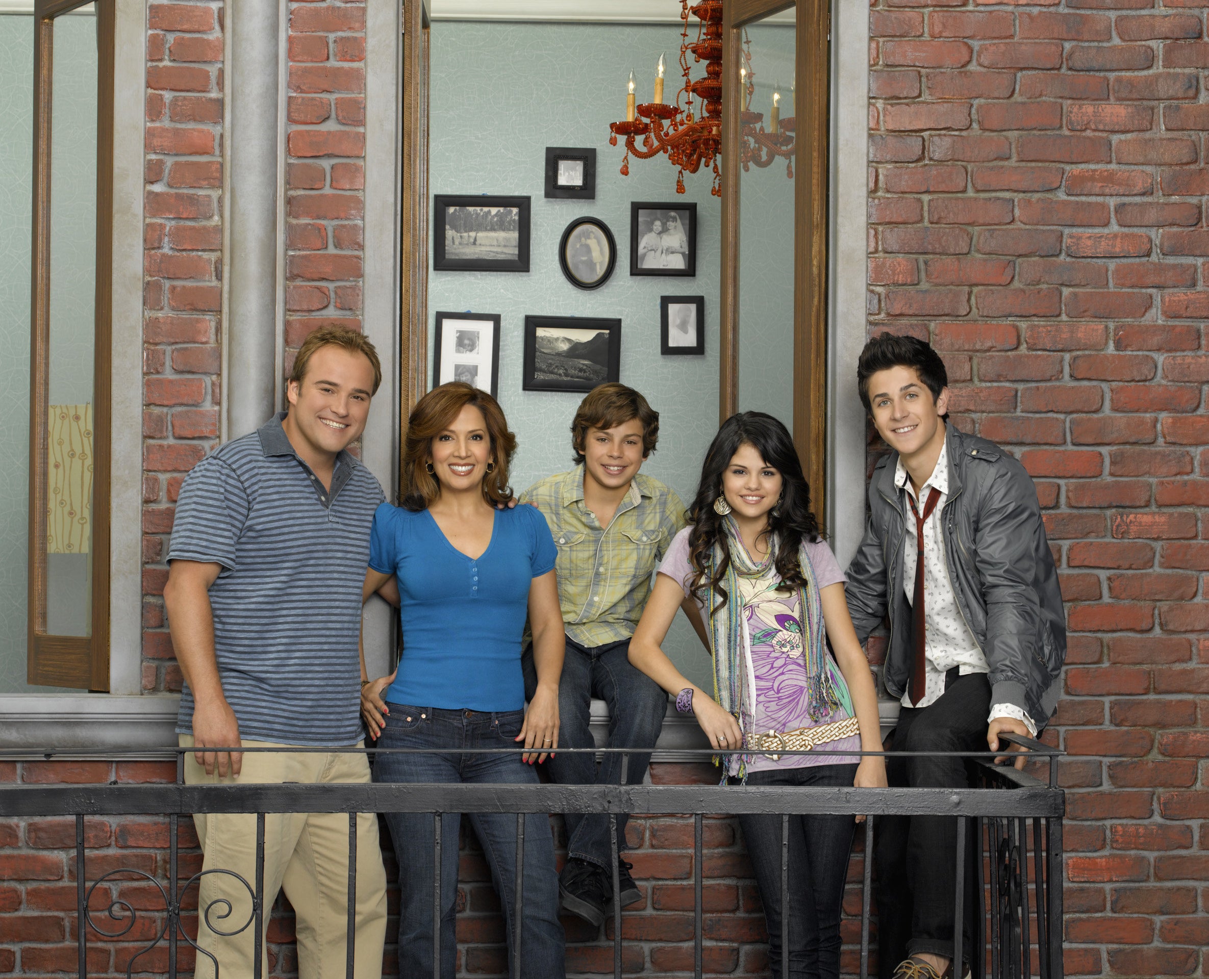 The cast of Wizards of Waverly Place stand on a fire escape