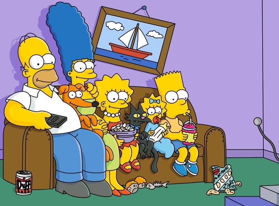 The Simpsons cast sit on a couch watching TV