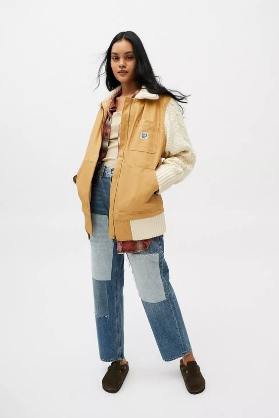 Model wearing the canvas bomber jacket over jeans and top