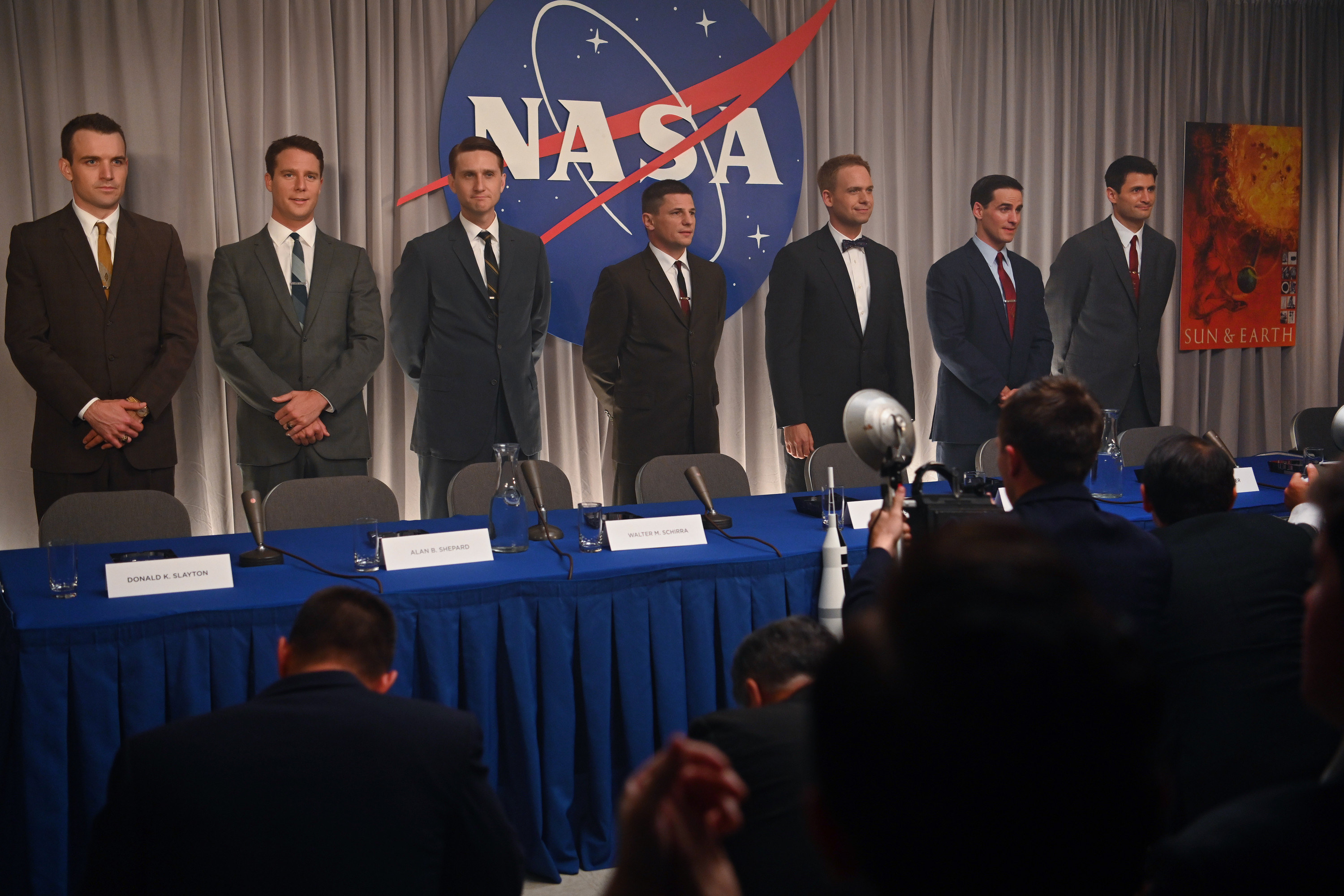 The cast of The Right Stuff stand behind a Nasa press conference table