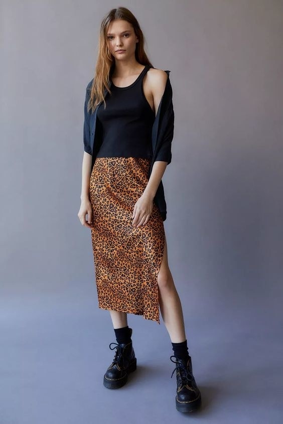 Model wearing the cheetah print dress with thigh-high side slit