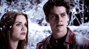 A close up of Stiles and Lydia as they stand in the snow