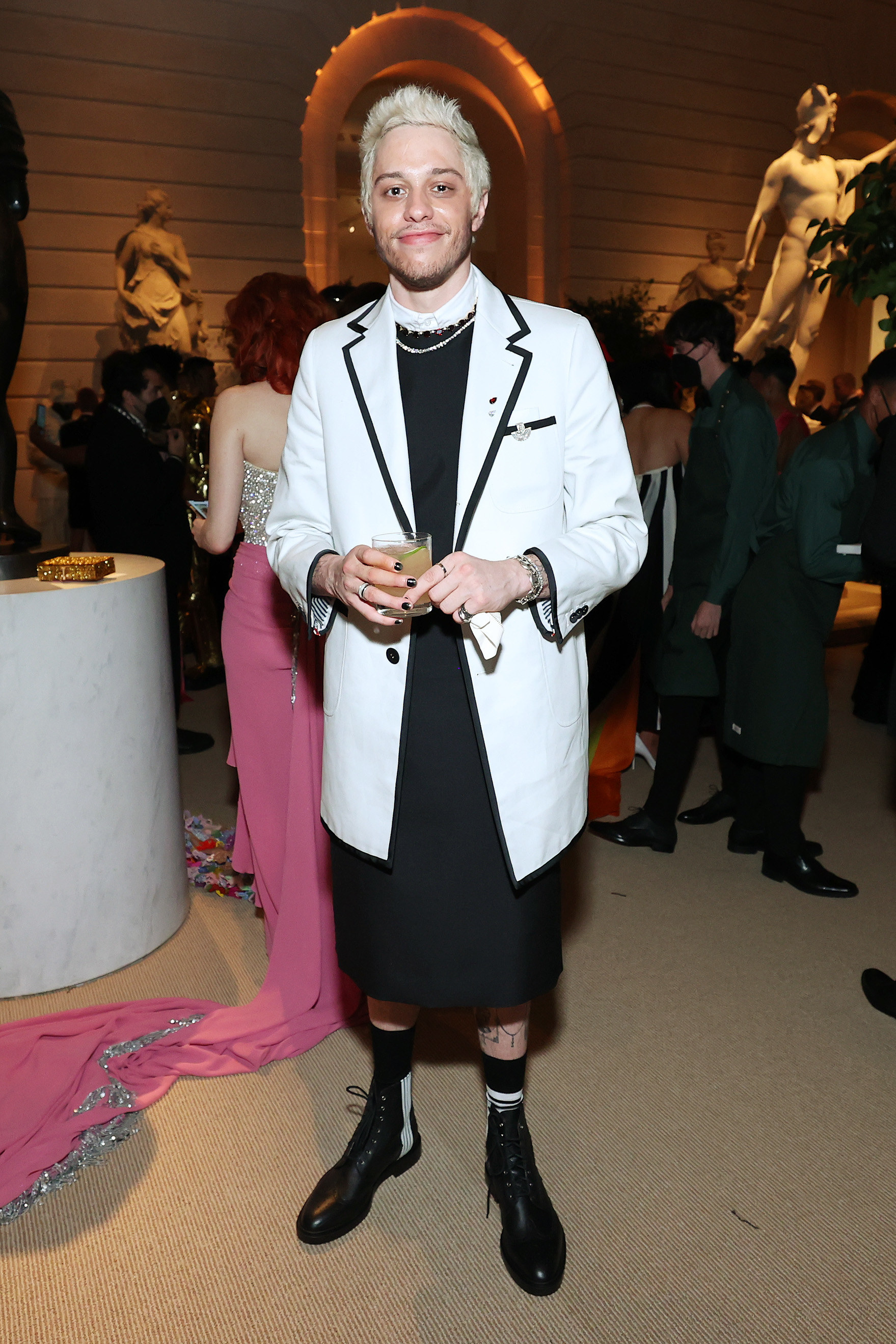 Pete at the Met Gala wearing a long blazer and skirt with ankle-length boots