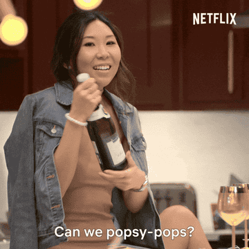 Natalie from &quot;Love Is Blind&quot; holding up a bottle of champagne saying &quot;can we popsy-pops?&quot;