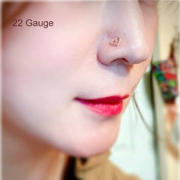 Model wearing the 22 gauge gold heart nose ring