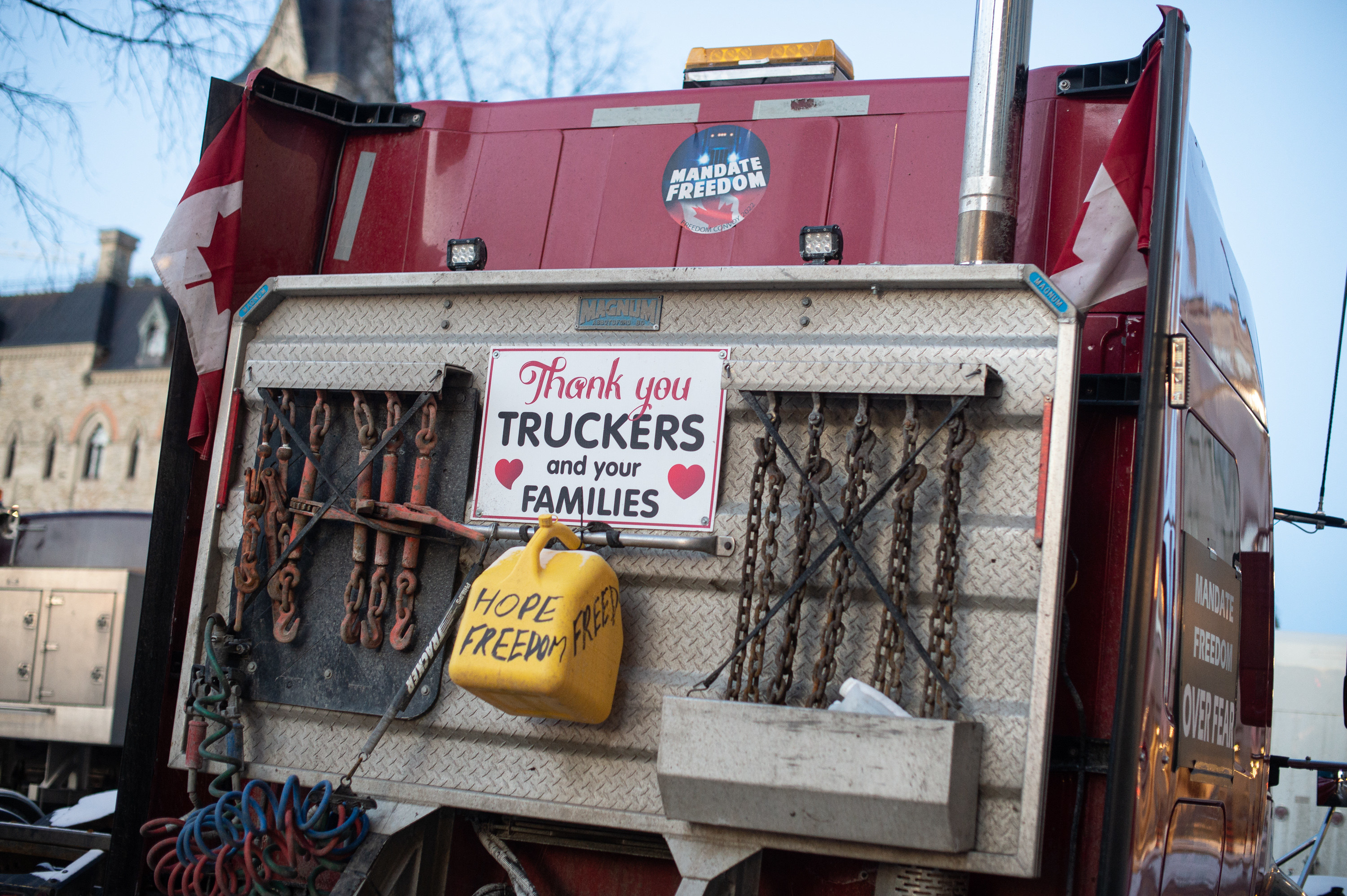 A sign on the back of a big rig truck reads &quot;thank you truckers and your families&quot; with a gas can marked &quot;hope freedom&quot;