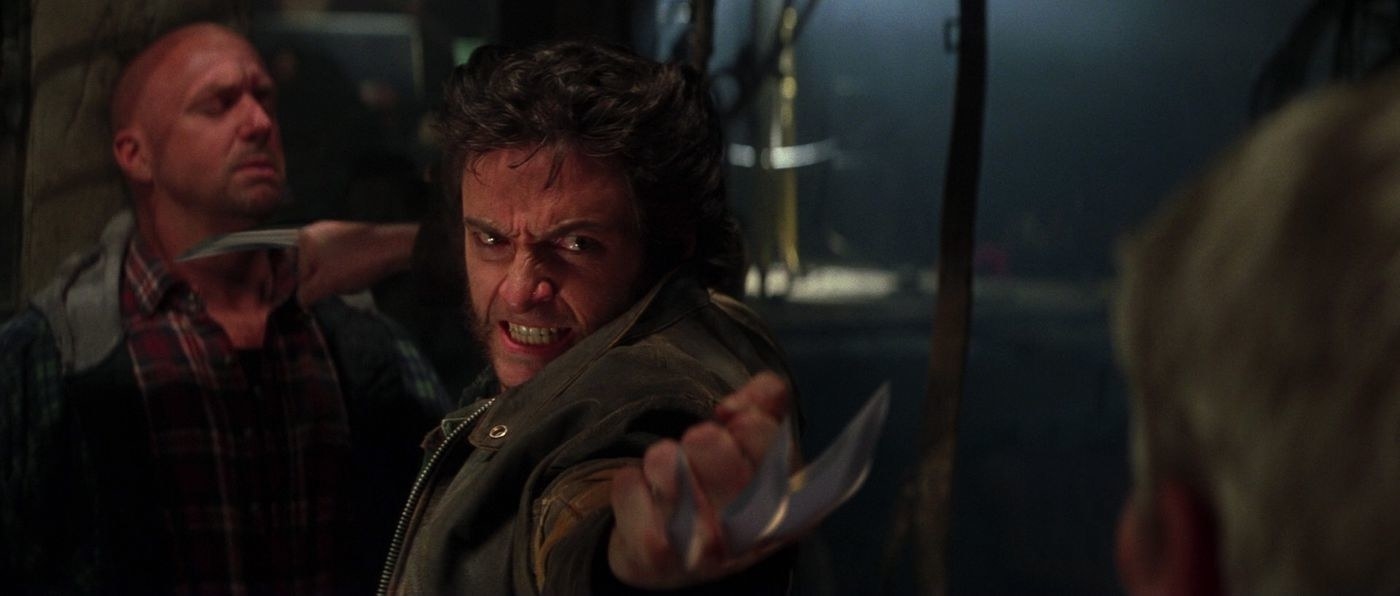 Wolverine fighting two men