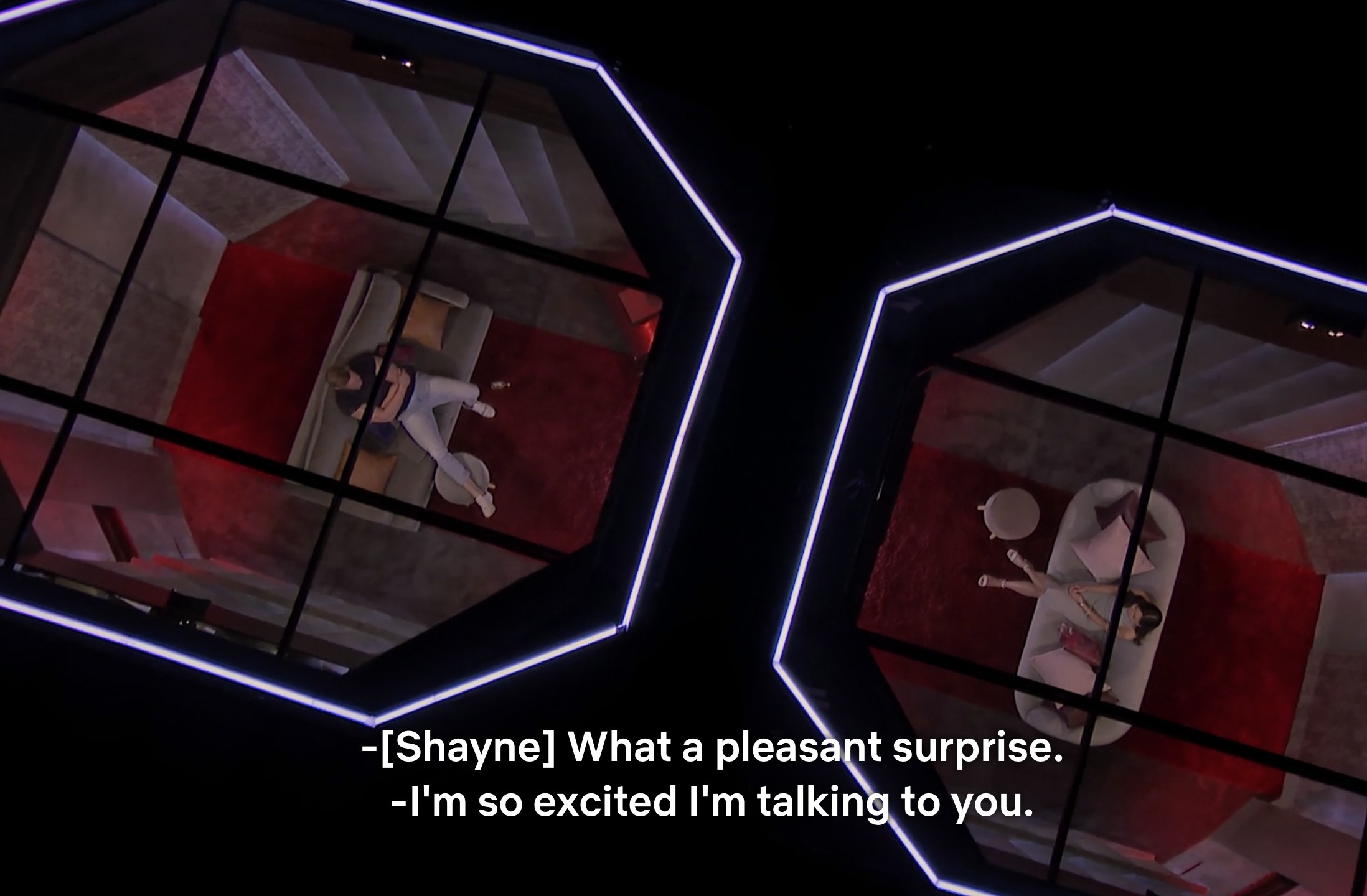 An aerial shot of Shayne and Natalie talking in the pods about being excited to connect with one another again