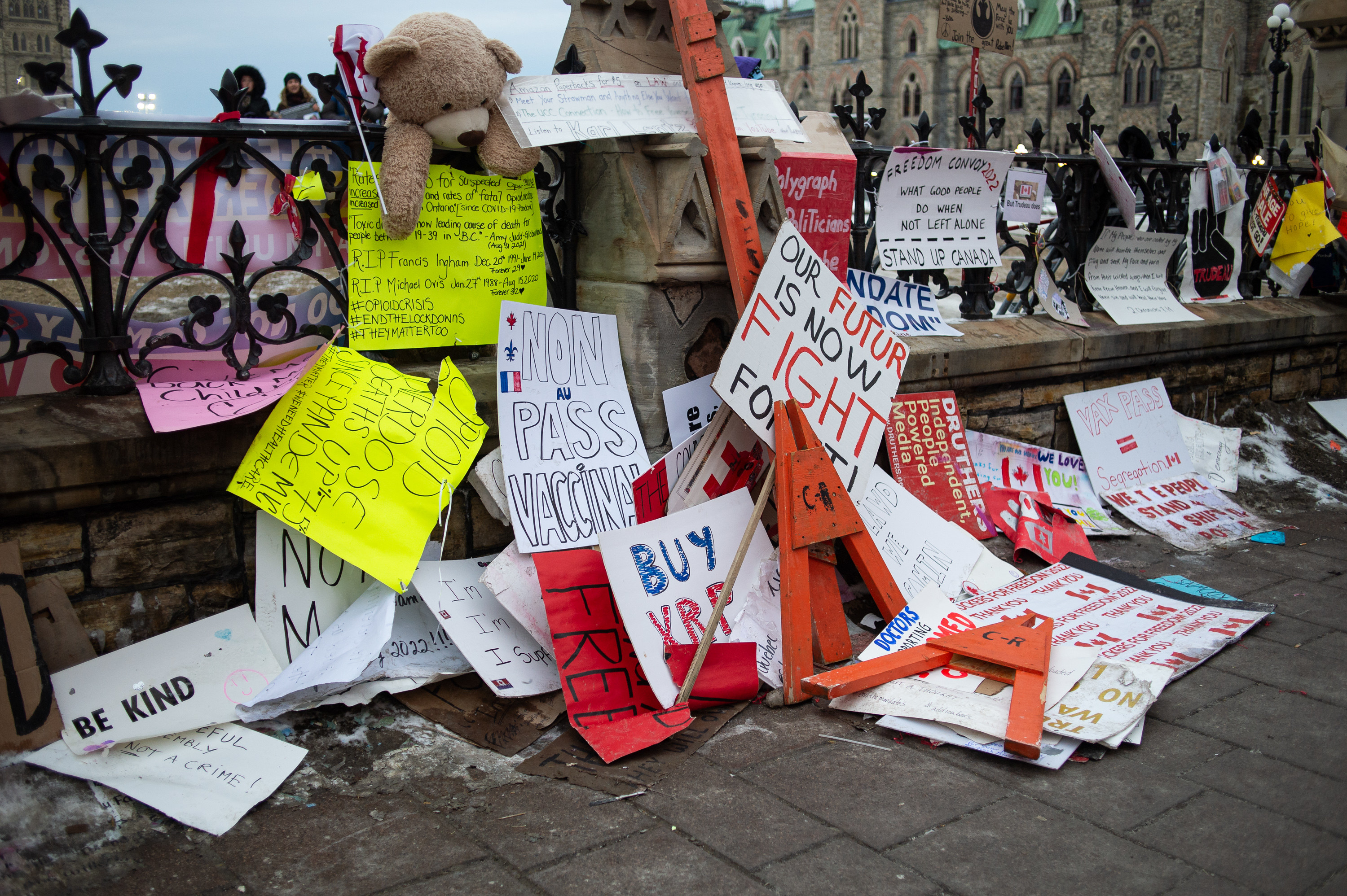 A pile of protest signs express anti-vaccine sentiments