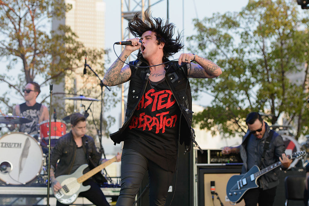 Lead singer Kellen Quinn of &quot;Sleeping with Sirens&quot; sings into a microphone on stage