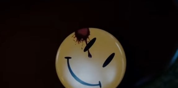 close up of a yellow smiley face pin with blood on it