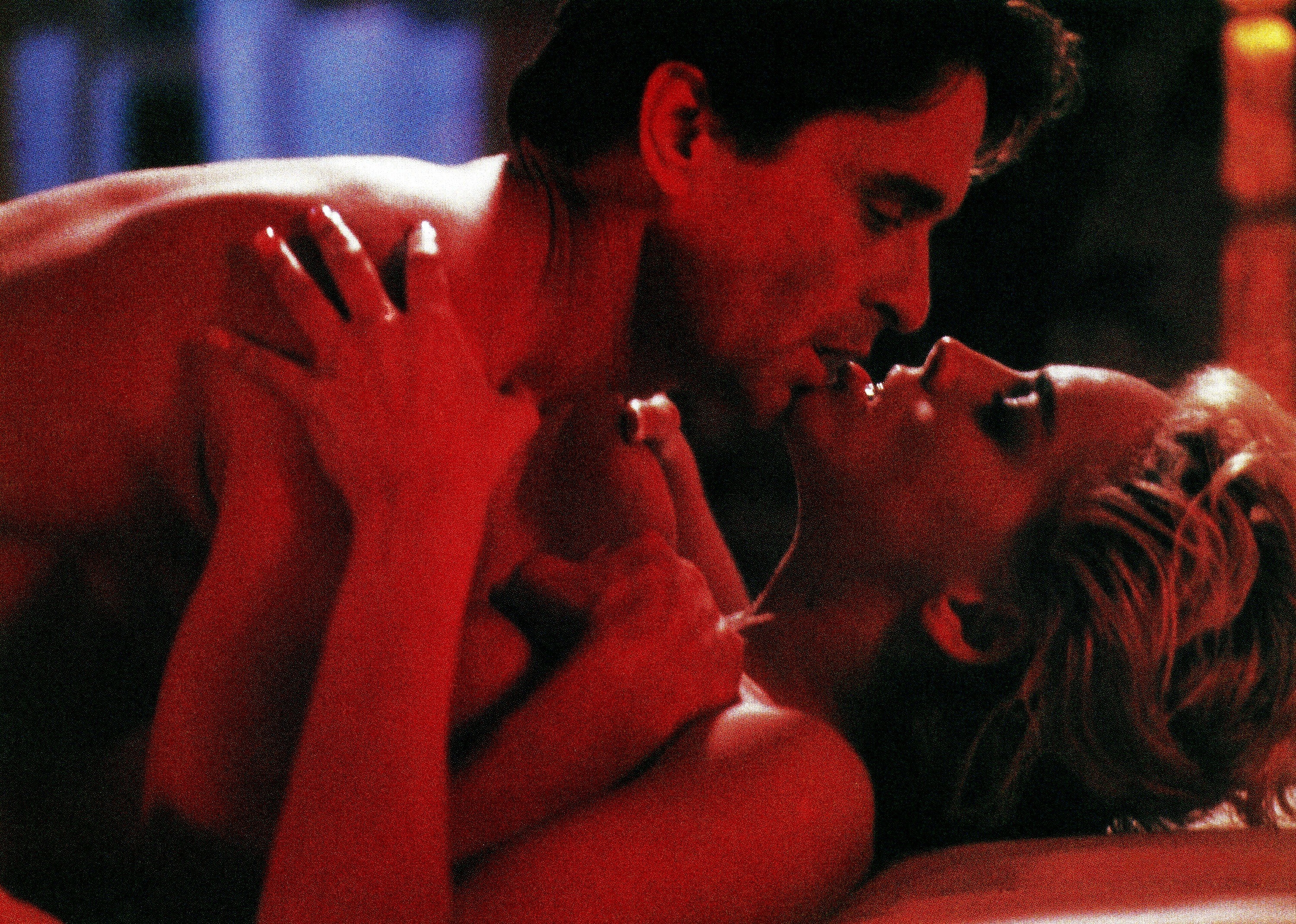 Michael lays on top of Sharon and kisses her in a scene from the film