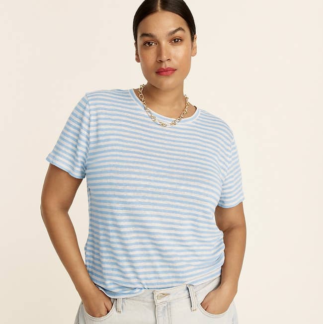 Model is wearing a white and light blue striped tee