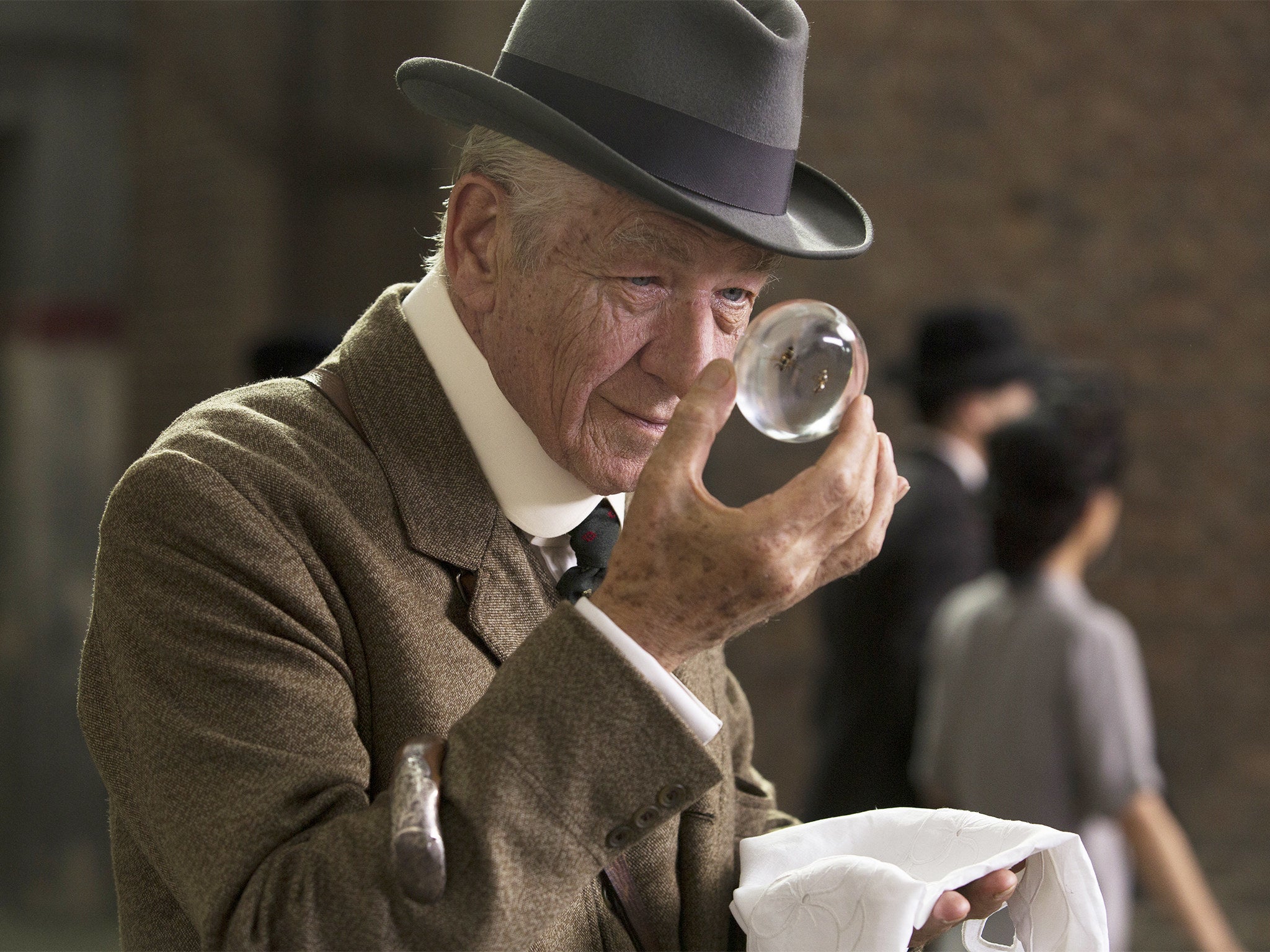 Ian McKellen looks at a magnifying glass