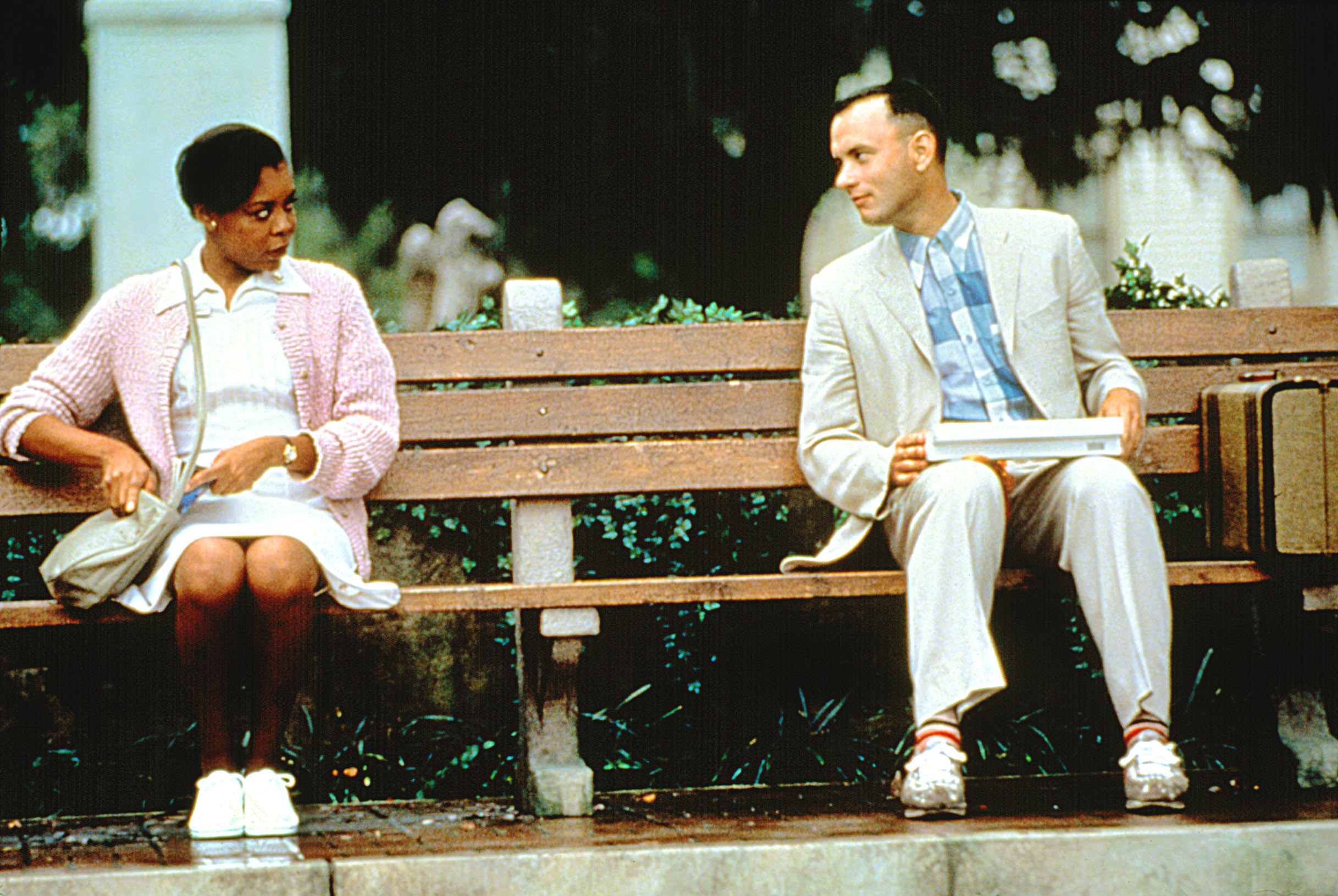 Rebecca Williams and Tom Hanks sit on a bench together