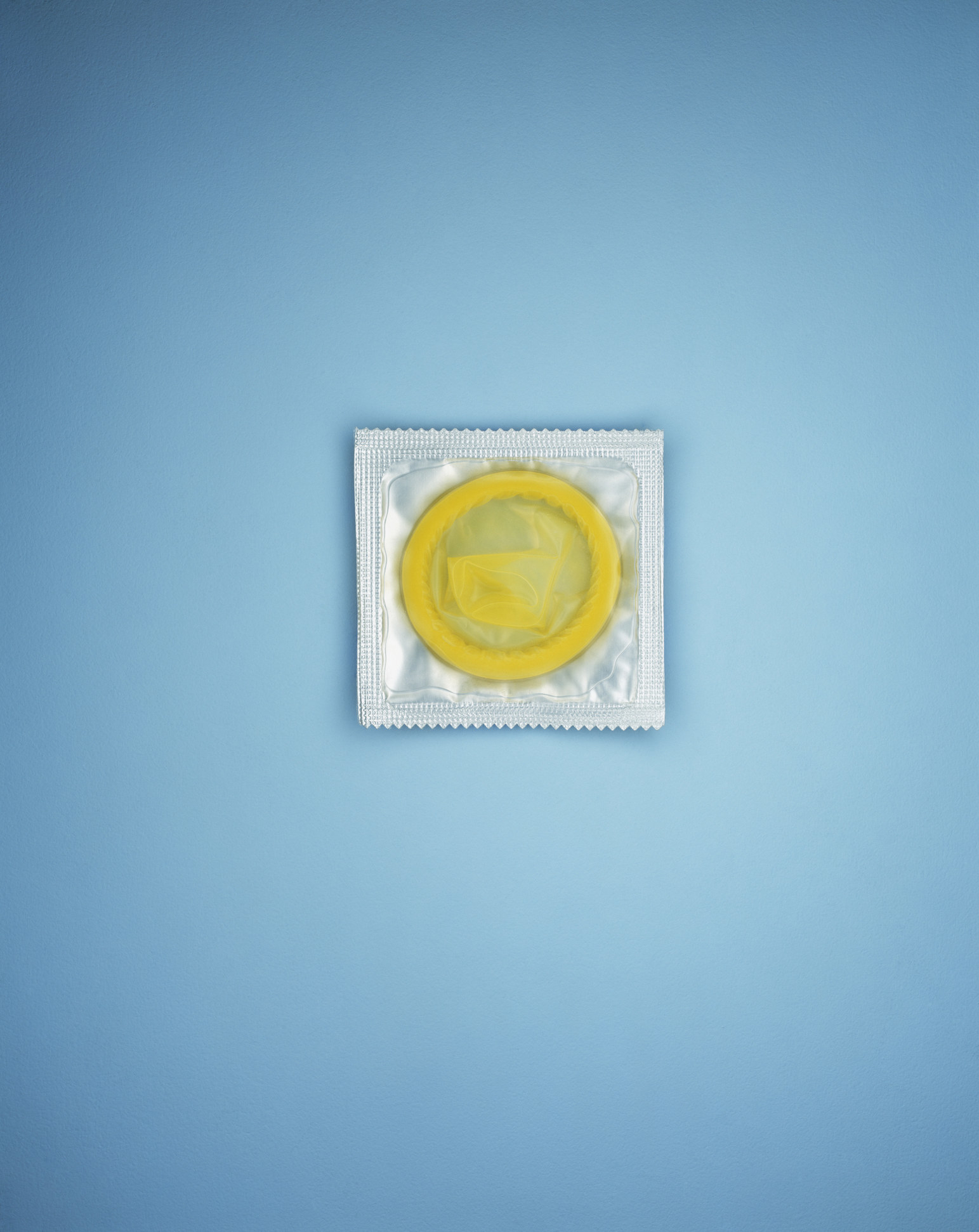 Stock image of a condom on a blue background