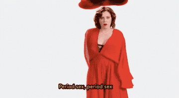 A GIF from the CW show &quot;Crazy Ex-Girlfriend&quot; showing Rachel singing the period sex song while dancing in front of a graphic of red blood
