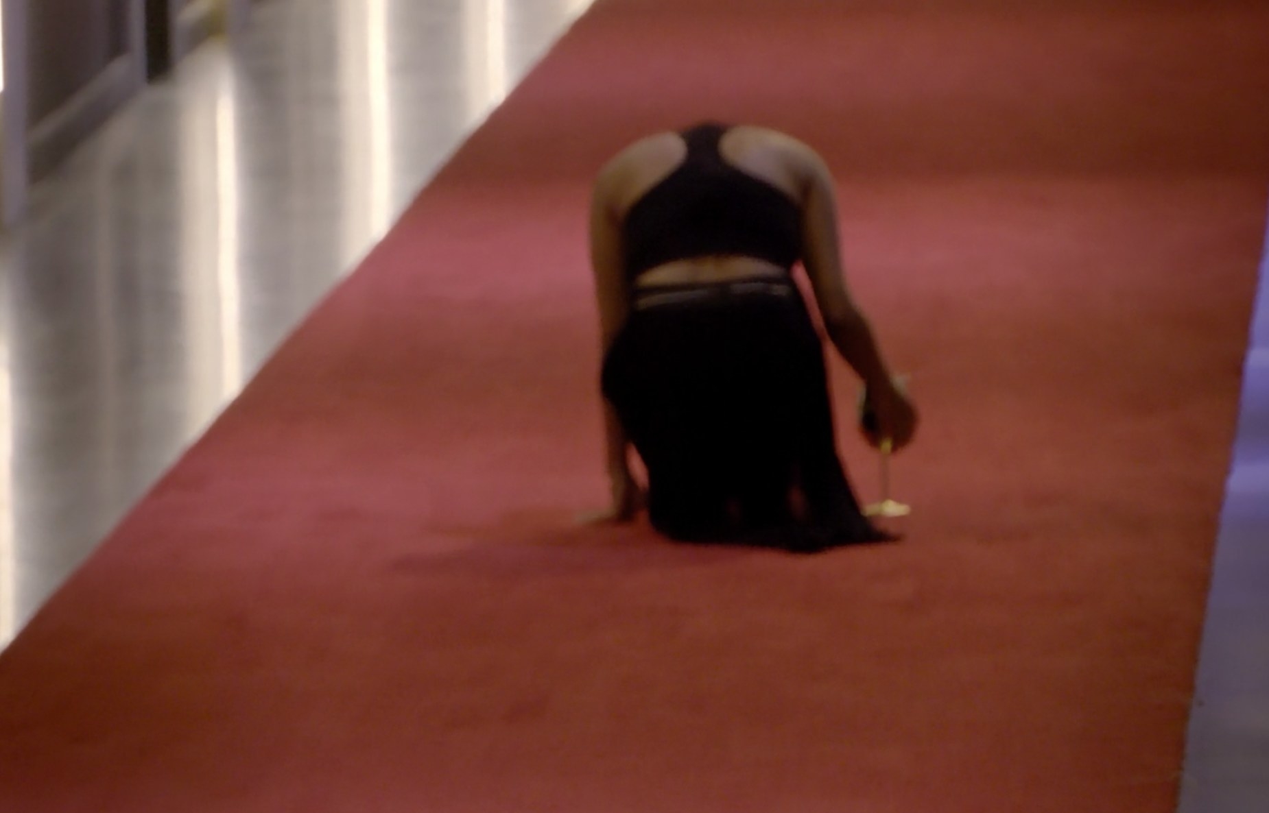 Iyana from behind kneeling on the floor in sadness