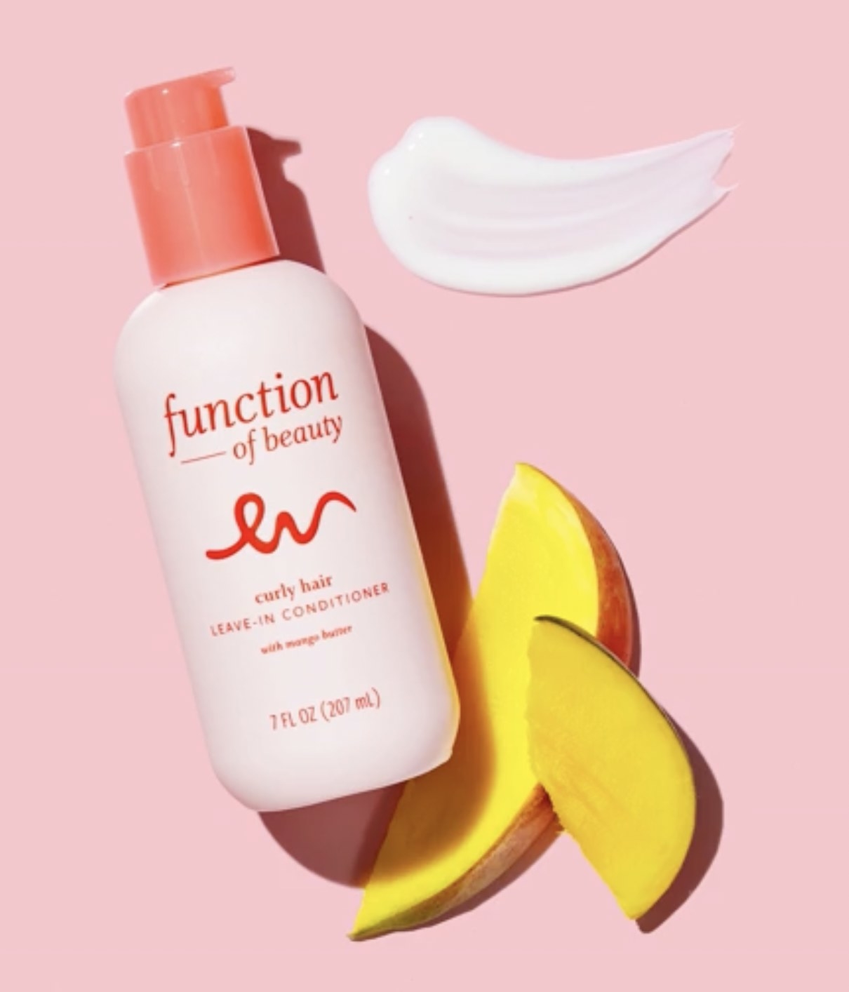 the leave-in conditioner in its bottle next to mango and a swatch of the product