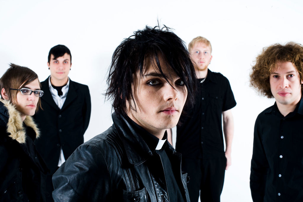 My Chemical Romance band members 	Gerard Way, Ray Toro, Mikey Way, and Frank Iero stand apart from each other in a posed photo
