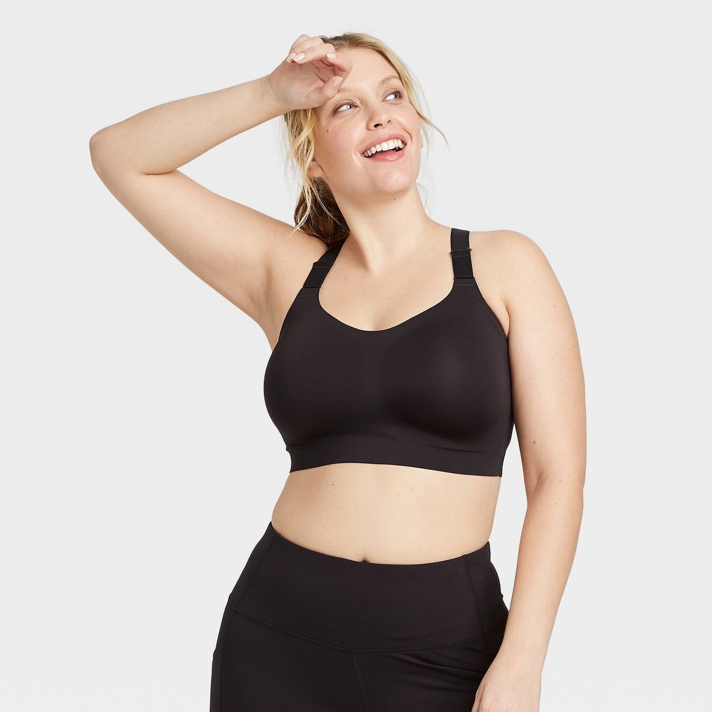 Model wearing the black high support bonded sports bra