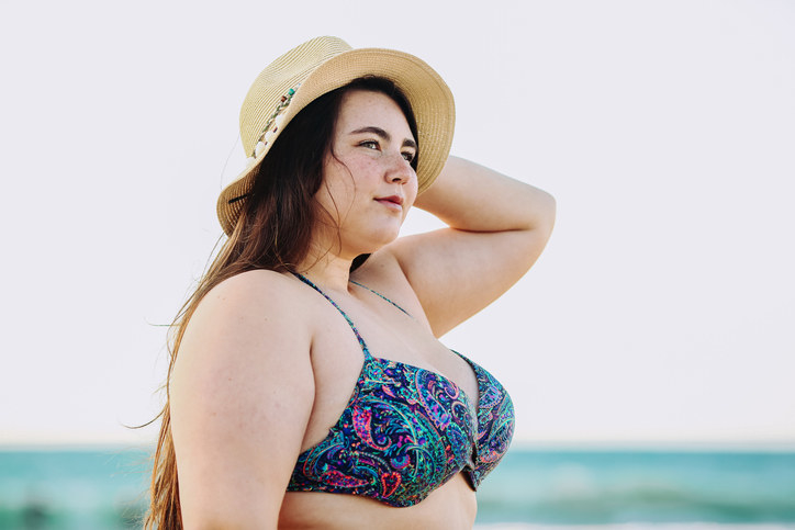 Plus-size person in a bathing suit at the beach