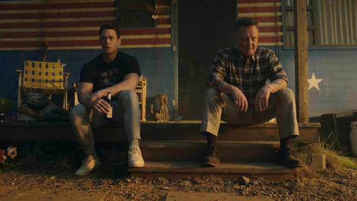 John Cena and Robert Patrick sitting outside Peacemaker&#x27;s cabin