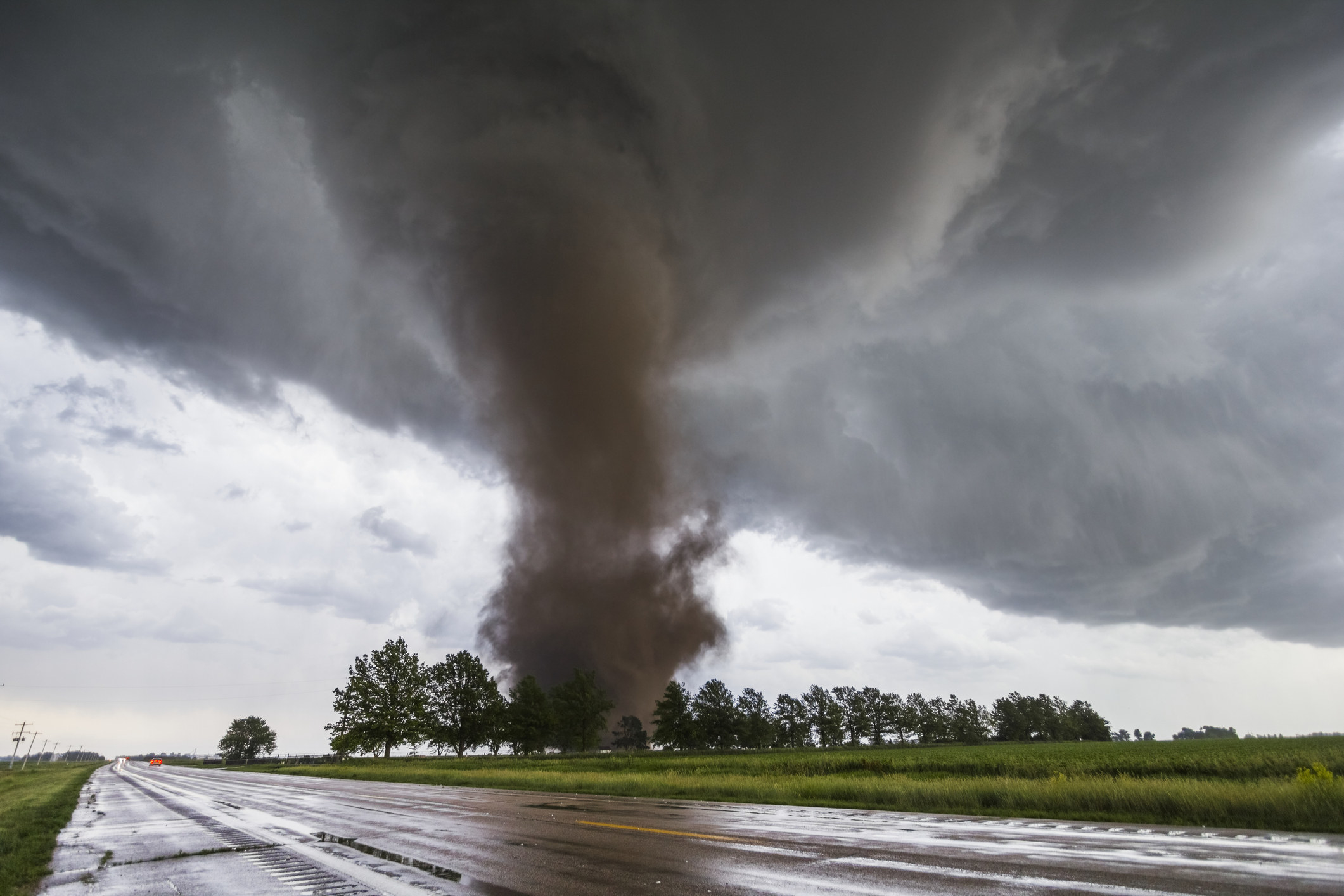 A large tornado approaches a field