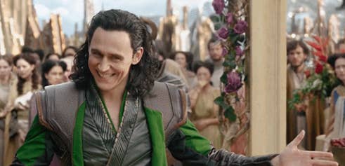Loki spreads his arms and smiles to the crowd