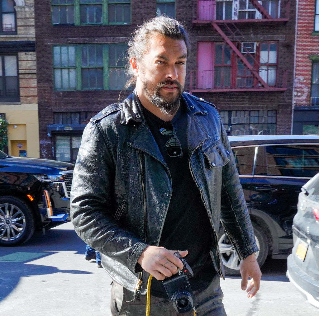 dressed in a cool leather jacket and skinny jeans, the actor carries his camera down the streets of NYC