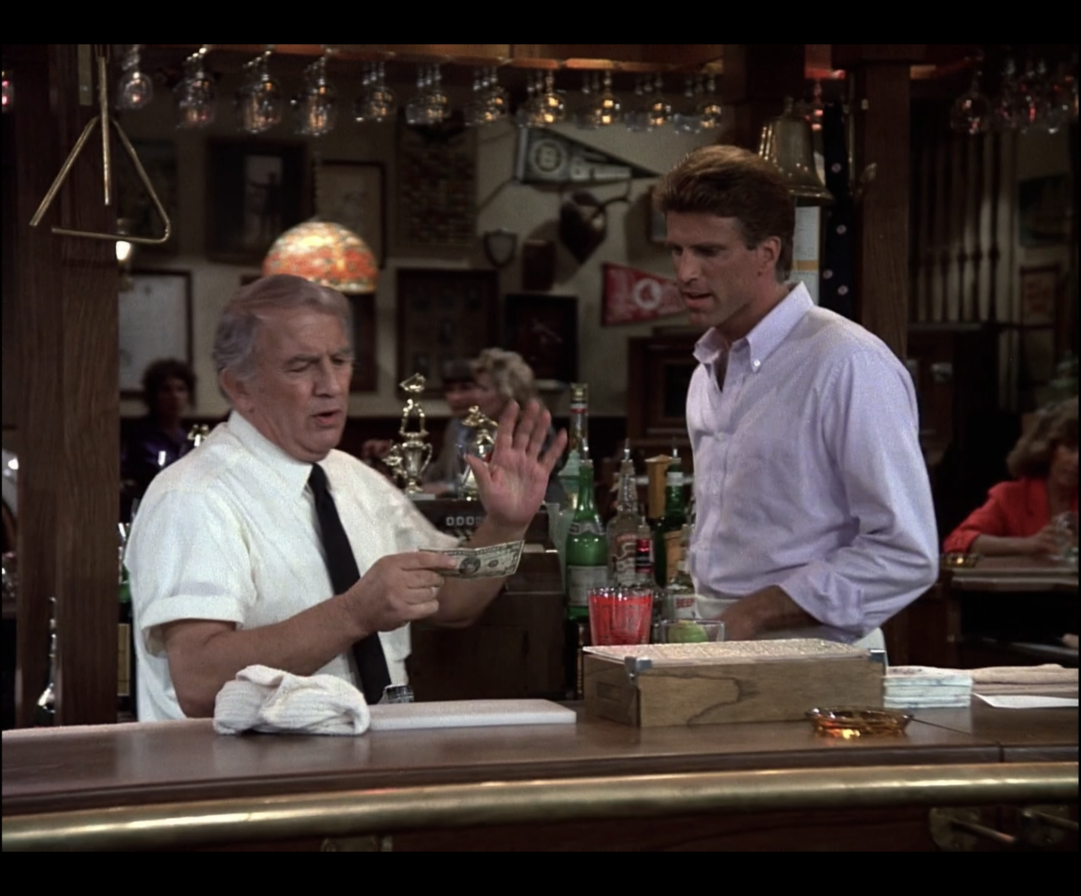 Ted Danson stands behind the bar