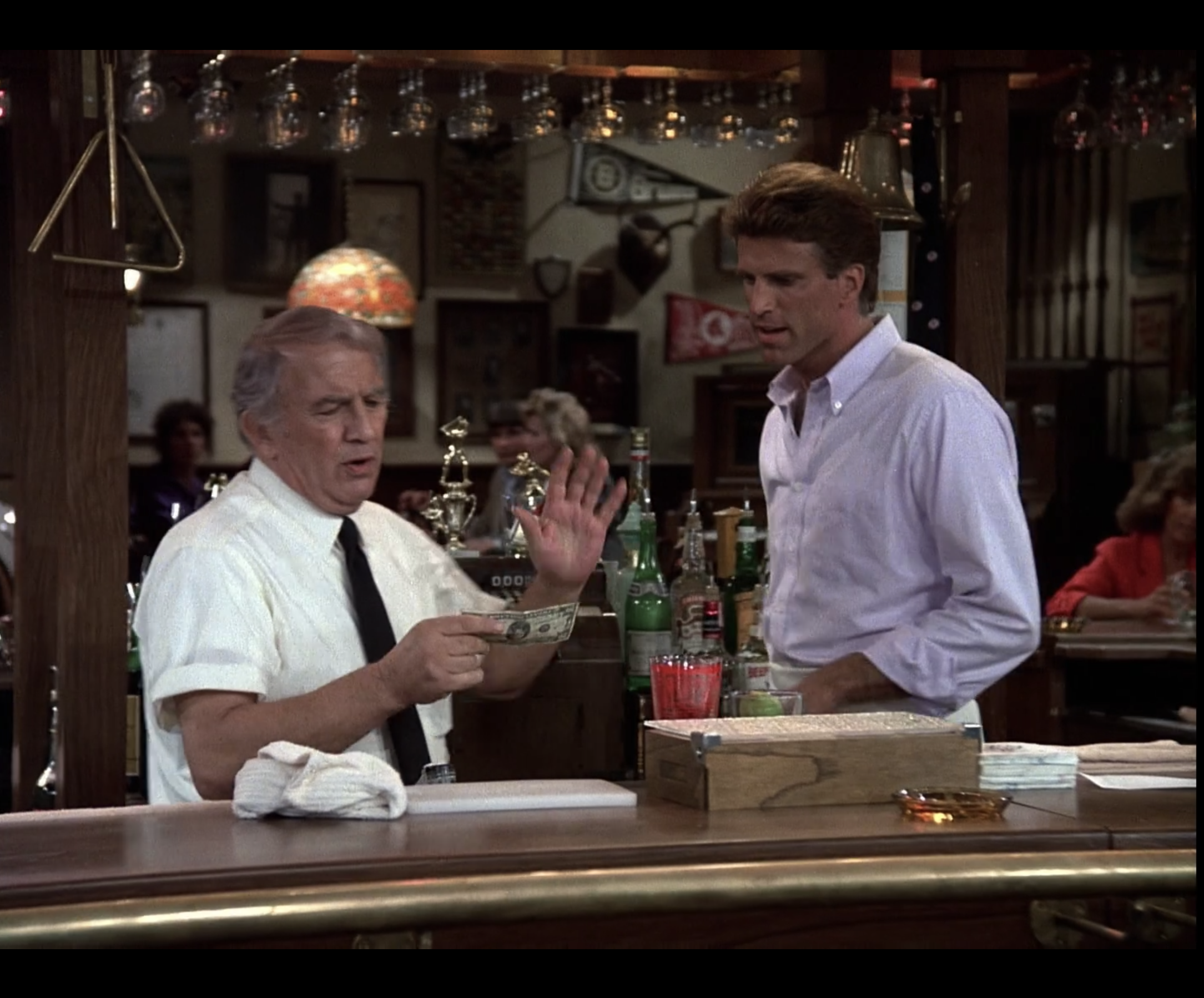 Ted Danson stands behind the bar