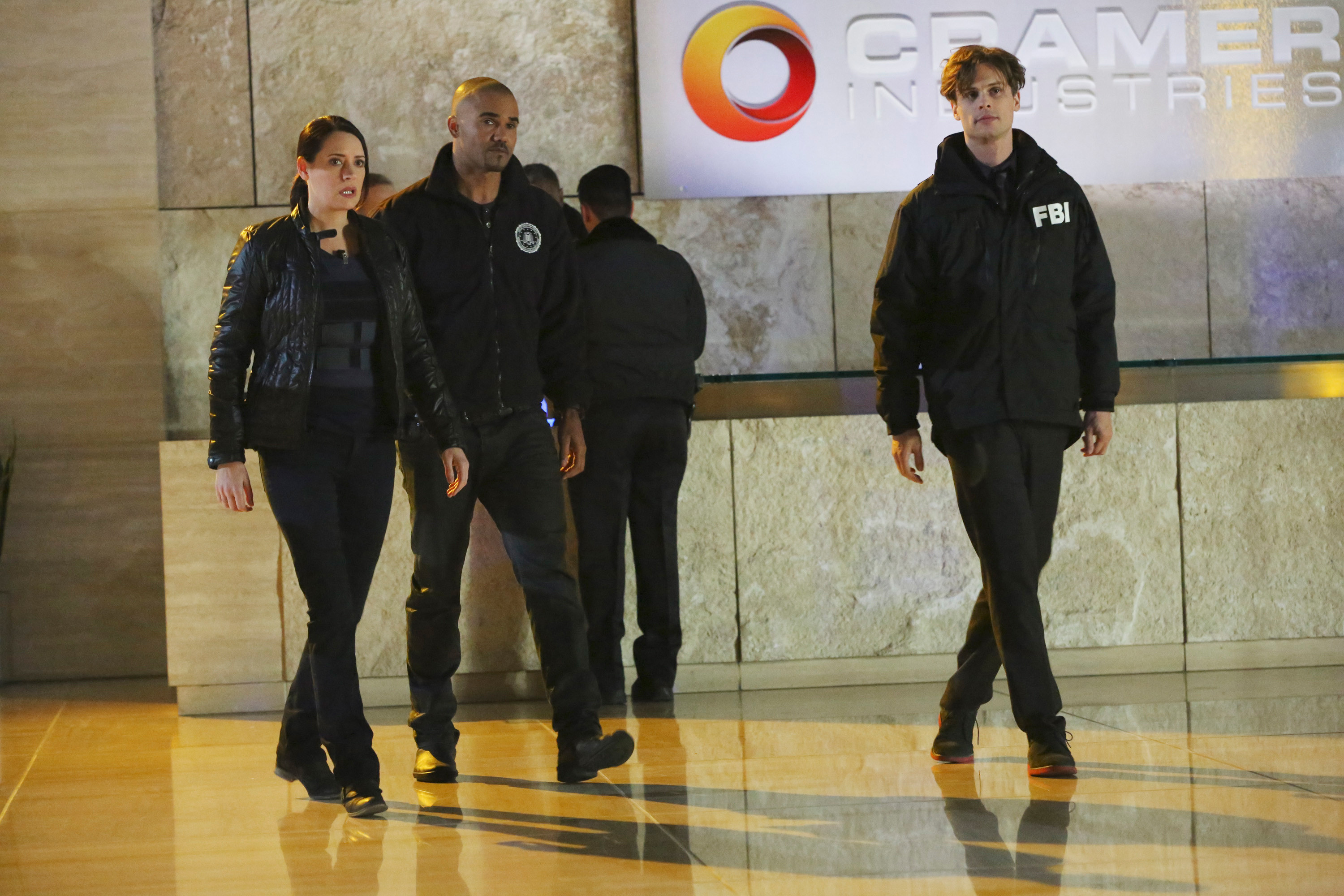 Derek, Prentiss, and Reid walk out in the FBI jackets