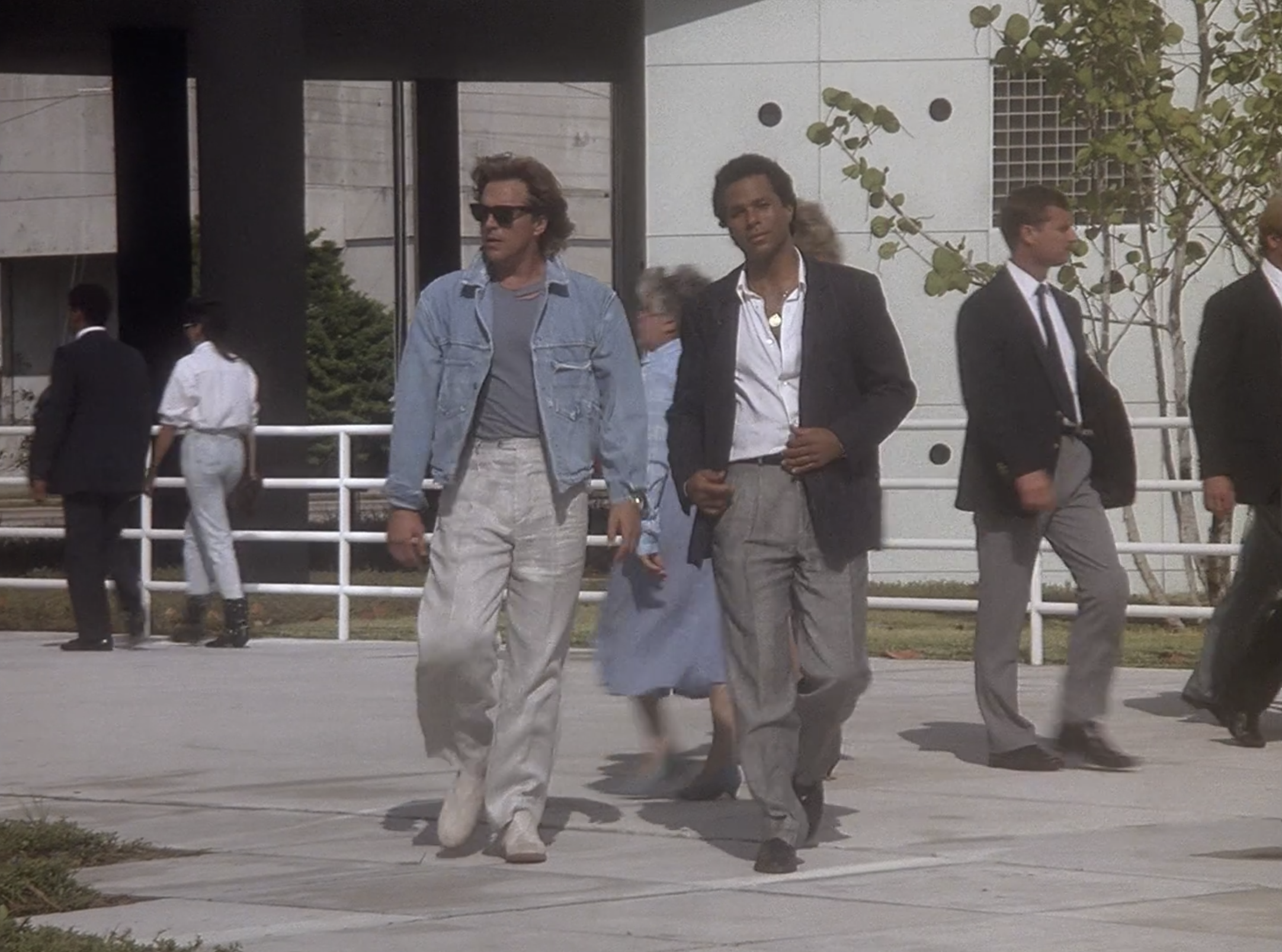 Don Johnson and Philip Michael Thomas walk out of a courthouse