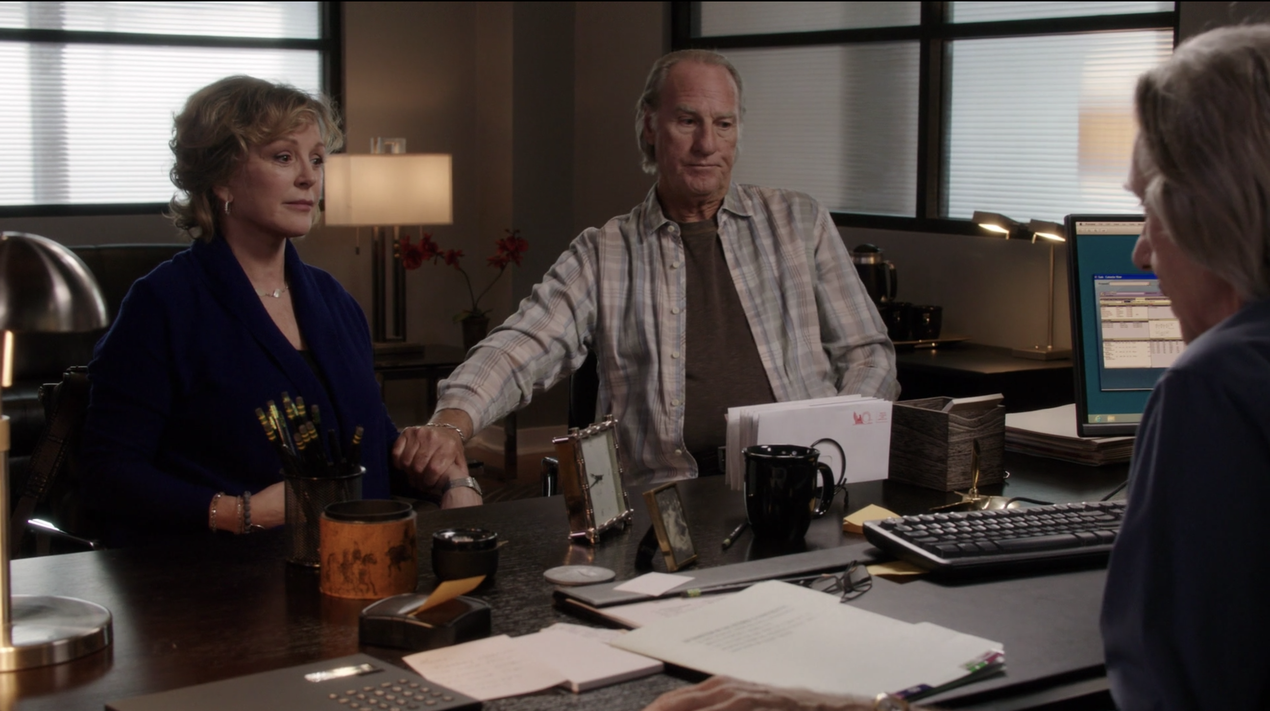 Craig T Nelson and Bonnie Bedelia sit in an office together