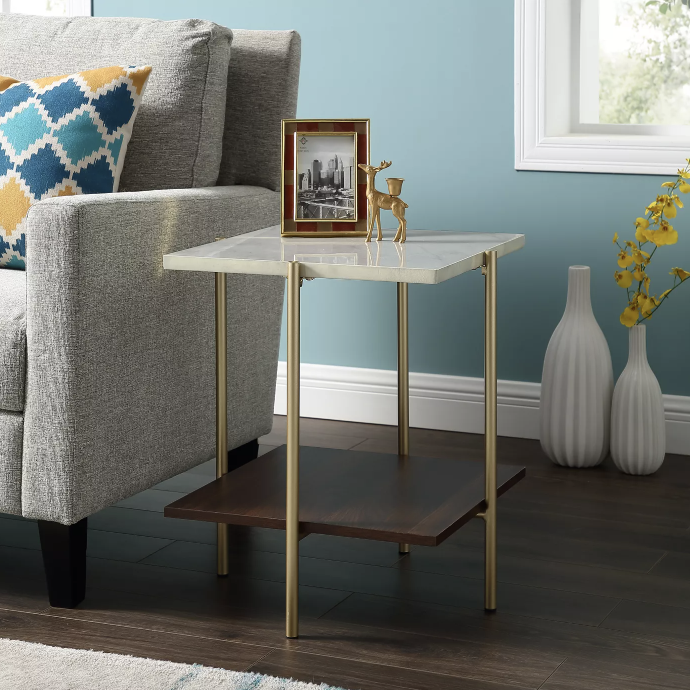 an end table with a white marble top, brass legs, and a walnut shelf