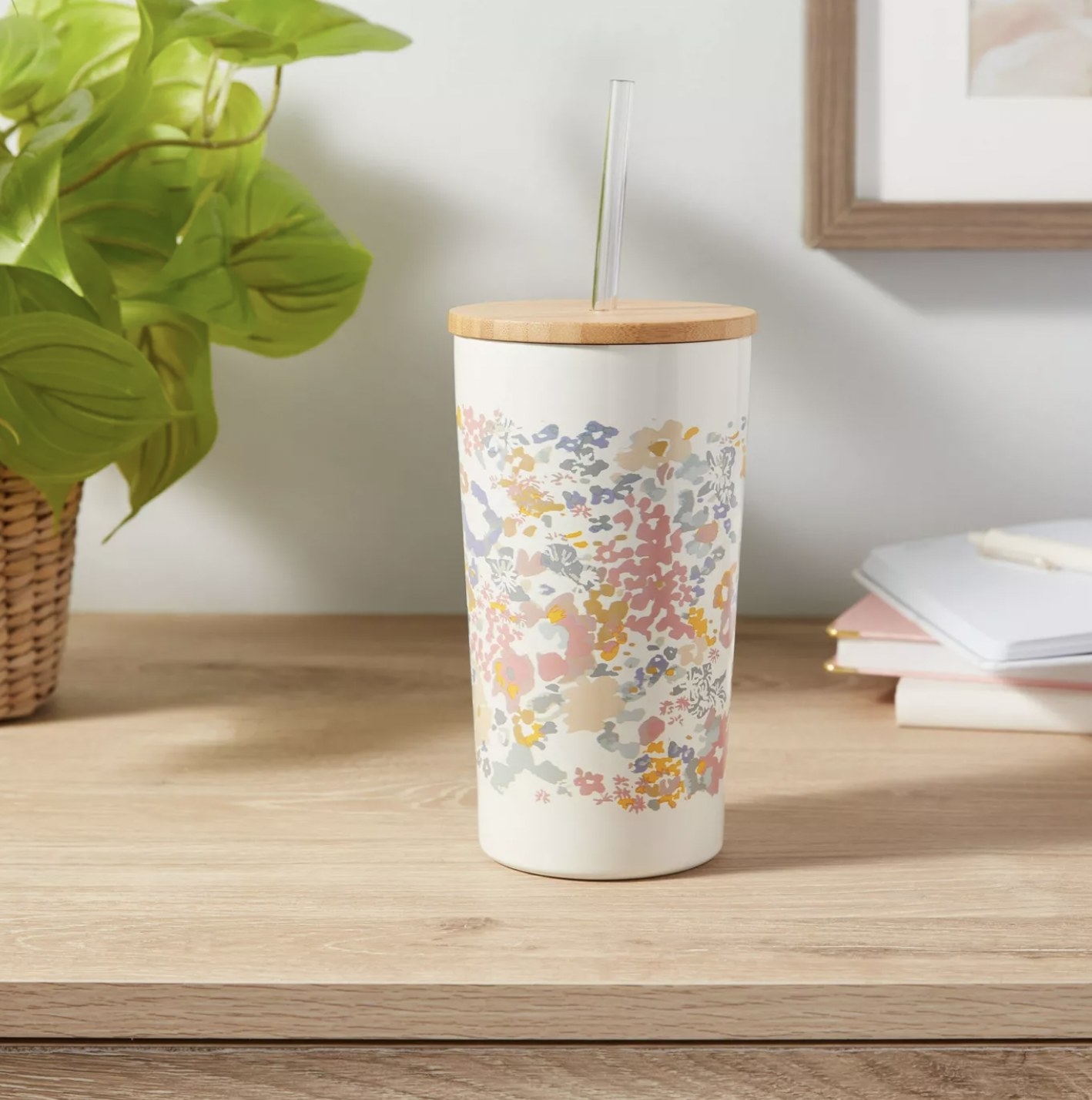 The white floral tumbler with wood lid and clear straw