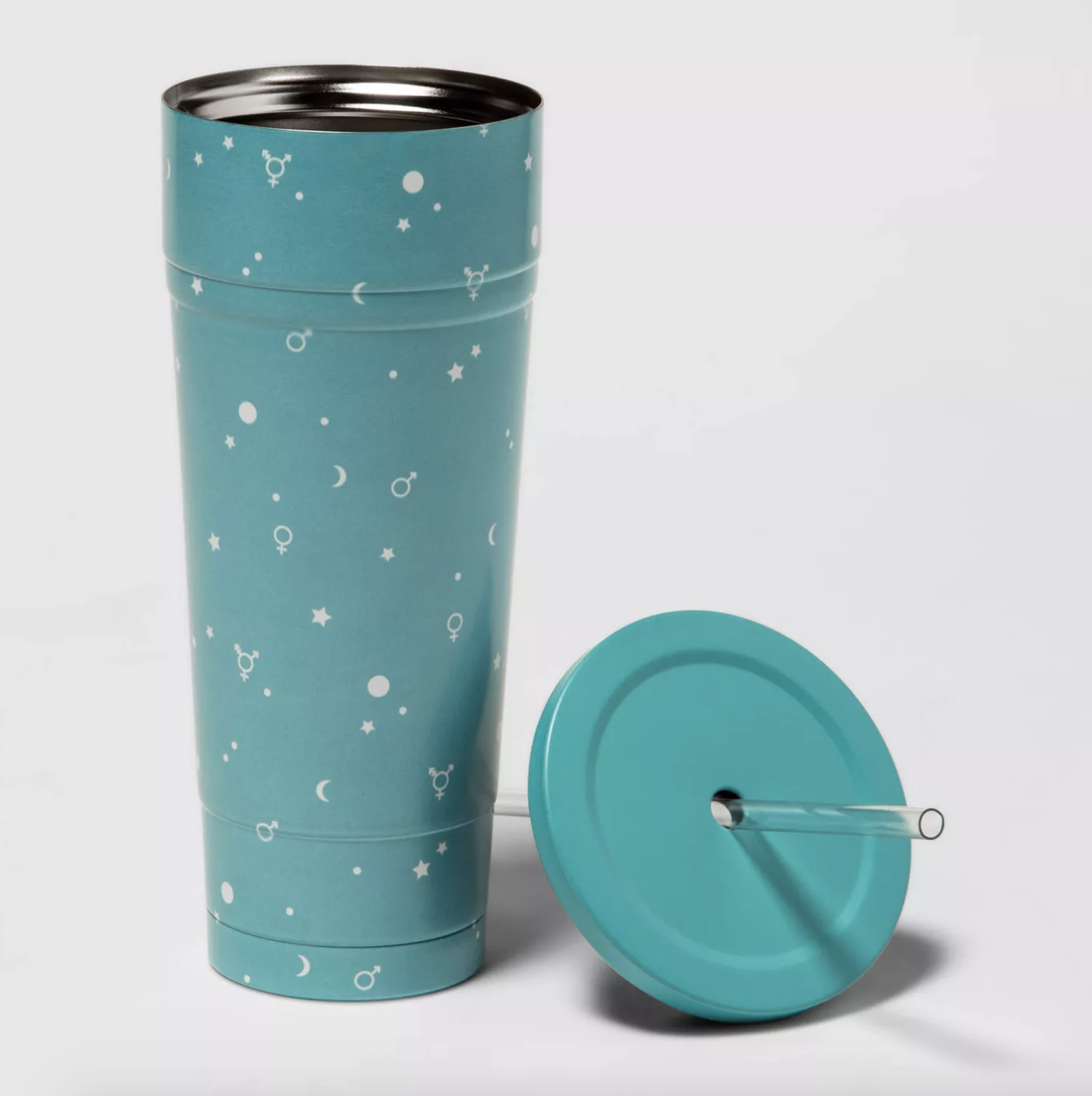 a blue tumbler cup with white stars and moon icons on it